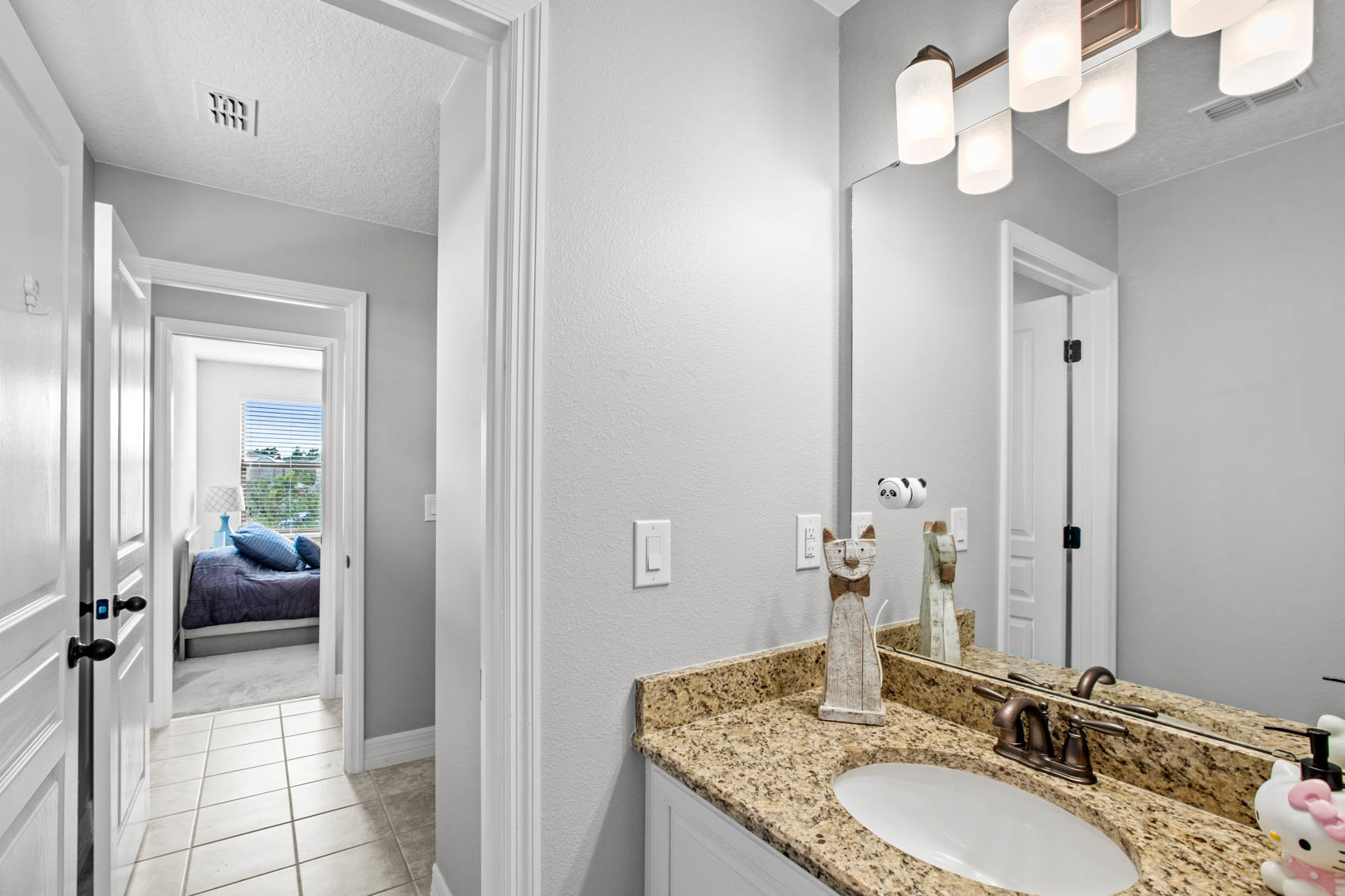 bathroom with personal sink and door looking into other bedroom